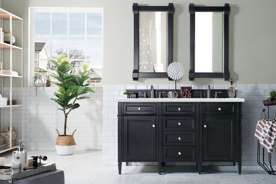 Bright bathroom with a Brittany 60" Double Bowl Vanity, white countertop, two mirrors, potted plant by a large window, shelving on the left for towels and toiletries, and white tile walls with a tiled floor.