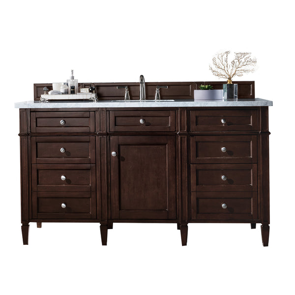 A dark wood bathroom vanity with multiple drawers and a central cabinet, topped with a white countertop, silver faucet, toiletries, and decorative items, set against a white background.