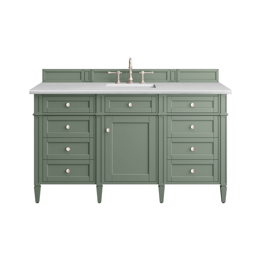 Green bathroom vanity with six drawers, one cabinet door, a white countertop, and a built-in sink with a gold faucet. The design is classic and symmetrical, with round handles on each drawer and door.