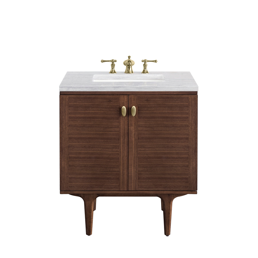 A wooden bathroom vanity with two cabinet doors, a white countertop, and a built-in sink. The sink features brass faucet handles and hardware.