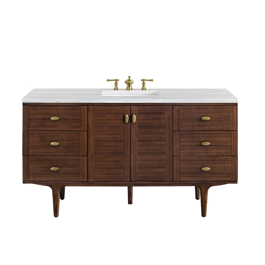 A mid-century modern bathroom vanity with a white countertop, built-in sink, brass faucet, and six drawers with brass handles, finished in dark wood.