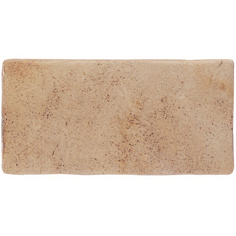A rectangular piece of plain, light brown focaccia bread with a slightly rough texture and small brown speckles evokes the rustic charm of Morocco 4x8 White Body Ceramic Tile designs.