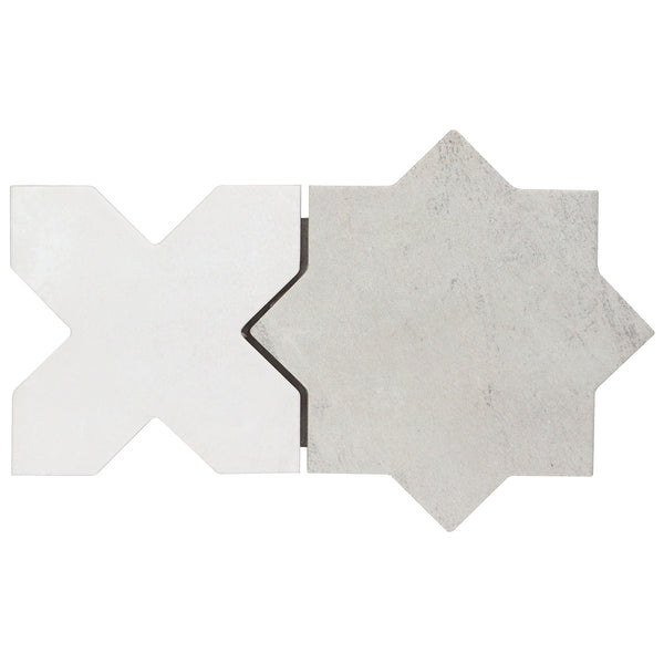A matte X-shaped tile in light matte white pairs with the Morocco Star & Cross Porcelain Tile in grey, both featuring subtle texture, placed side by side on a white background.
