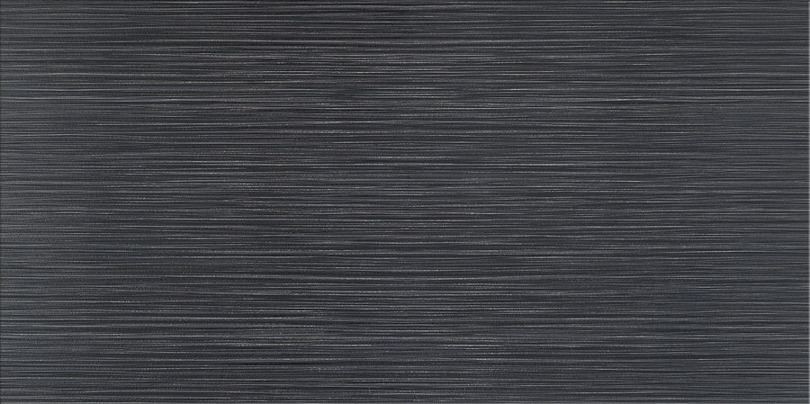 The Linea 12" x 24" Ceramic Tile in Shadow features a dark gray textured surface with thin, uneven white stripes, bringing movement and depth while its minimal, abstract style is ideal for contemporary interiors.