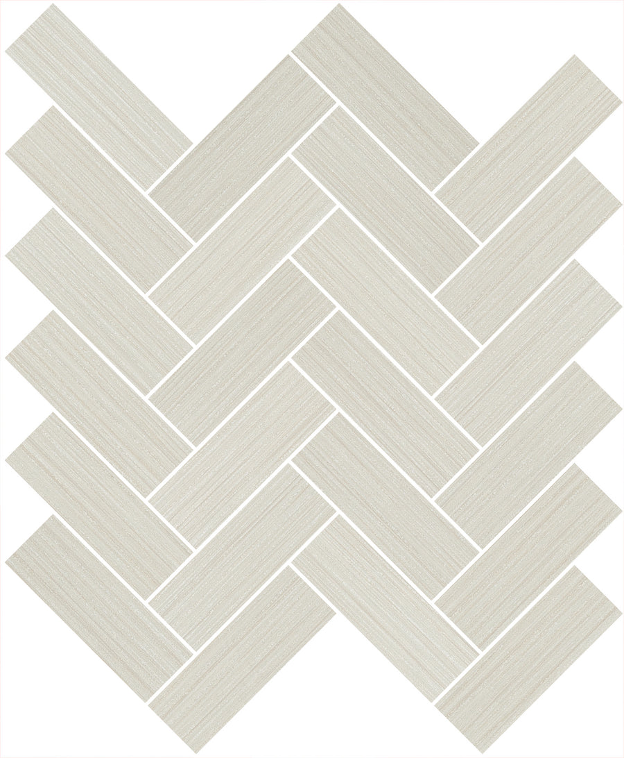 Linea 1" x 4" Herringbone Mosaic Tile in Crème features a rectangular, light beige hue with subtle wood grain texture, arranged diagonally in a herringbone pattern on a white background.
