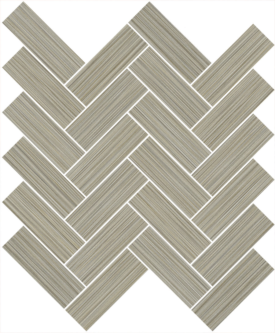 The Linea 1" x 4" Herringbone Mosaic Tile in Dried Thyme features rectangular tiles with subtle horizontal stripes, arranged diagonally—ideal for a chic kitchen backsplash or a sleek, modern bathroom design.