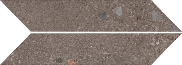 Two Strata Chevron tiles in Earthen color display geometric elegance with elongated, parallelogram shapes and a brown stone texture featuring subtle gray shades and colorful fragments on a durable surface.