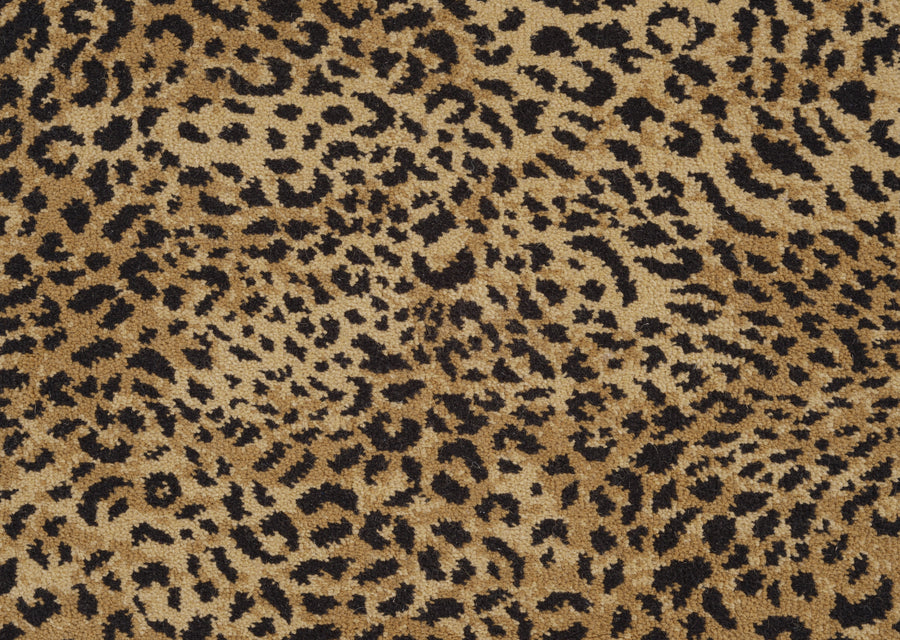 Close-up of the Leopard Ax On Trend Carpet in Natural, showcasing irregular black and dark brown spots on a tan background—ideal for adding bold style and durable flooring to any space.
