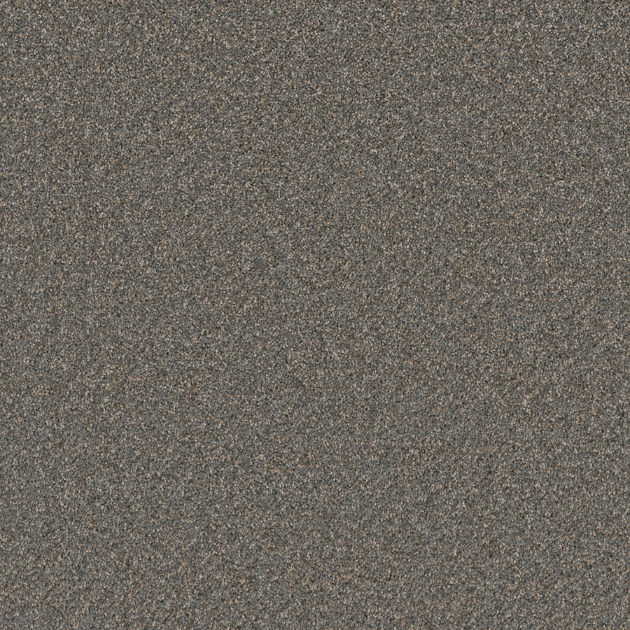 A close-up of Cosmopolitan II Family Friendly Carpet showcases coarse, dark grains in brown, gray, and black tones, offering a heavy, soft texture ideal for sophisticated interiors with an Iron Frost-inspired look.