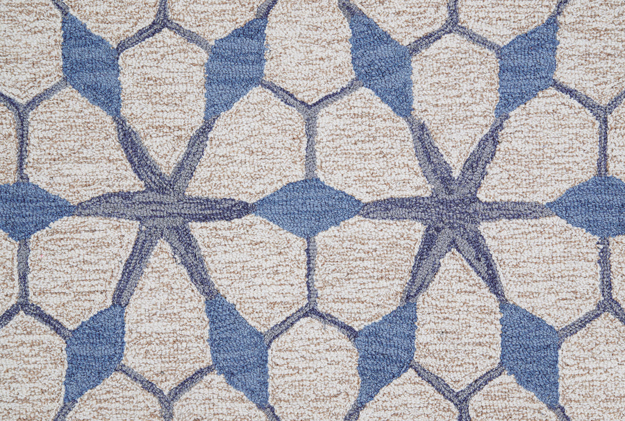 A close-up of the Yakima Berber Carpet in blue highlights its textured, geometric pattern—ideal as a durable option for premium flooring.