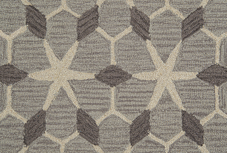 A close-up of Yakima Berber Carpet, a durable beige carpet with a repeating geometric design—ideal for premium flooring.