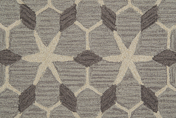 A close-up of Yakima Berber Carpet, a durable beige carpet with a repeating geometric design—ideal for premium flooring.