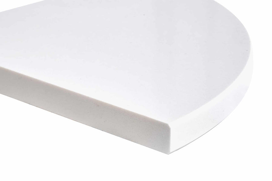 A close-up of a thick, white, solid, quarter-circle or pie-shaped object, shown against a plain white background.