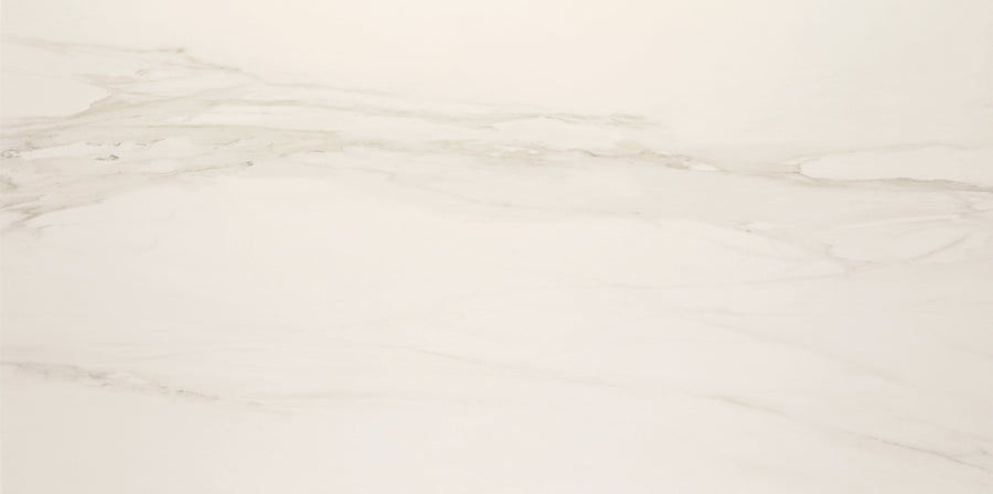 The Lunara Haze Rectified 24" x 48" Tile in Natural features a white marble look with subtle diagonal gray veining and a seamless, polished surface for an elegant, minimalist style.