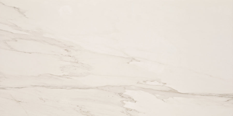 Lunara Haze Rectified 24" x 48" Tile features a polished white marble look with subtle diagonal grey veining. Rectified edges deliver seamless grout lines, while its neutral palette highlights the tile’s smooth texture and soft color variations.