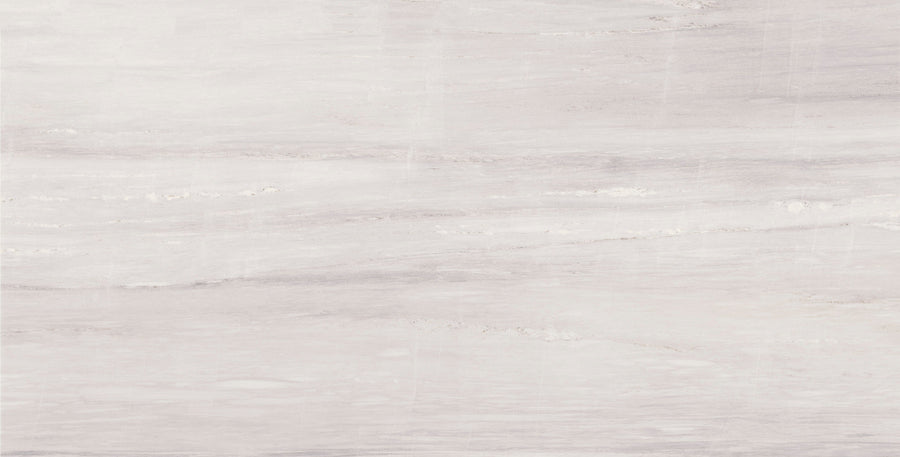 The Lunara Comet Rectified 24" x 48" Tile in Natural features a light gray marble look with soft veining and subtle color variations, offering a smooth, elegant surface in a large format.