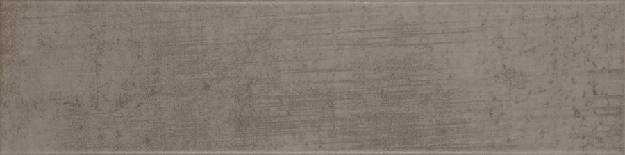 The Urban Glow 4" x 16" Subway Tile in Pewter features a textured surface with gray and brown tones, subtle uneven horizontal streaks, and a slightly distressed look for a modern yet weathered style.
