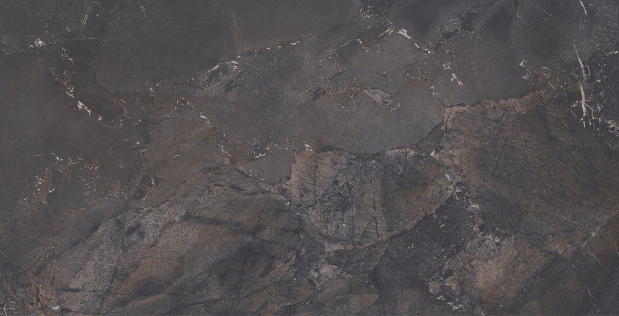 The Cavallo Dusk Rectified 12" x 24" Tile in Natural features a dark stone look with black, brown, and gray tones. Irregular cracks and marbled patterns give this premium tile the appearance of rugged, natural texture.