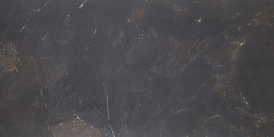 The Cavallo Dusk Rectified 24" x 48" Tile in Natural features a matte finish with dark, textured surfaces and subtle veining, creating a marble-like look ideal for contemporary interiors.
