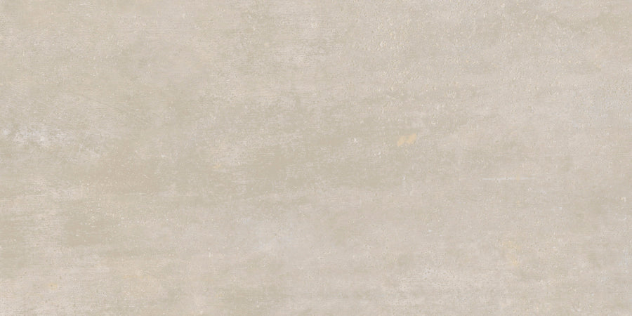 The Hans.A Rectified 12" x 24" Tile in Medium features a textured, medium beige surface with subtle color variations and faint marks, offering a seamless installation and a slightly rustic, weathered look reminiscent of concrete.