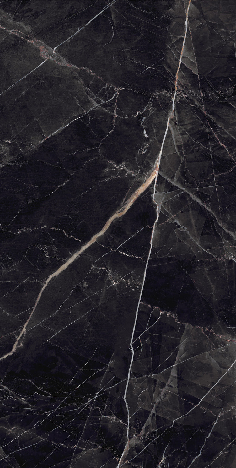 A close-up view of a dark marble surface with white and light brown veins running diagonally, creating a natural, abstract pattern.