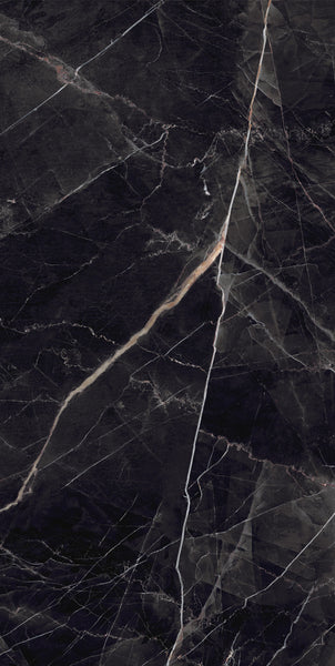 A close-up view of a dark marble surface with white and light brown veins running diagonally, creating a natural, abstract pattern.