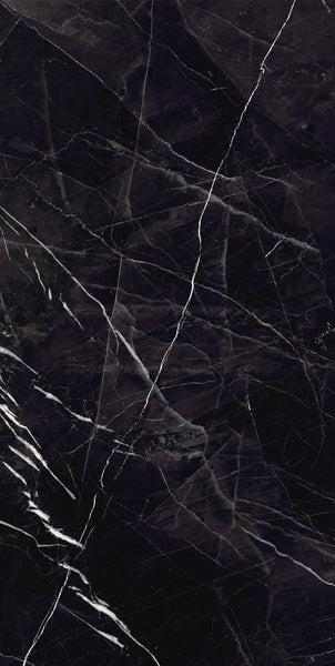 A close-up of dark black marble with white and gray veining patterns running diagonally and vertically across the smooth surface. The natural stone texture gives a polished, elegant appearance.