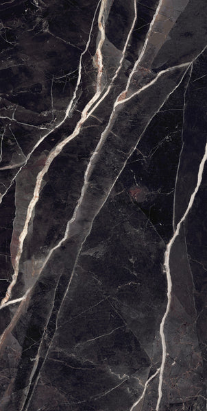 Dark marble surface with dramatic white and pale brown veins running diagonally across the stone, creating a striking, natural pattern with a glossy finish.
