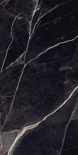 Close-up of a black marble surface with white and light beige veins running diagonally across it, creating an elegant and natural pattern typical of polished stone.