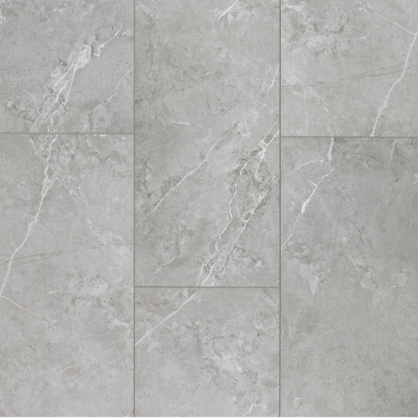 Close-up of Coretec CT Plus Tile Luxury Vinyl Tile in light gray with white veining and a matte, slightly textured finish, arranged in a staggered pattern. Enjoy the elegant look of marble stone with the durability of luxury vinyl.