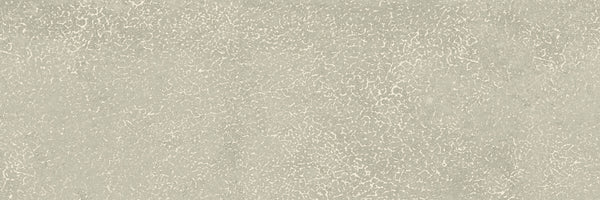 The Avanti 4x12 Glazed Porcelain Tile features a light gray, slightly rough matte surface with a subtle cracked pattern that evokes weathered concrete, offering a calming and uniform textured aesthetic.