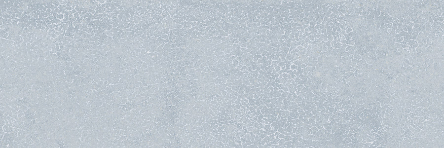 The Avanti 4x12 Glazed Porcelain Tile features a light gray textured surface with a subtle crackled pattern, resembling weathered concrete—perfect for creating a calming, natural aesthetic.