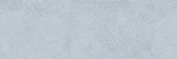 The Avanti 4x12 Glazed Porcelain Tile features a light gray textured surface with a subtle crackled pattern, resembling weathered concrete—perfect for creating a calming, natural aesthetic.