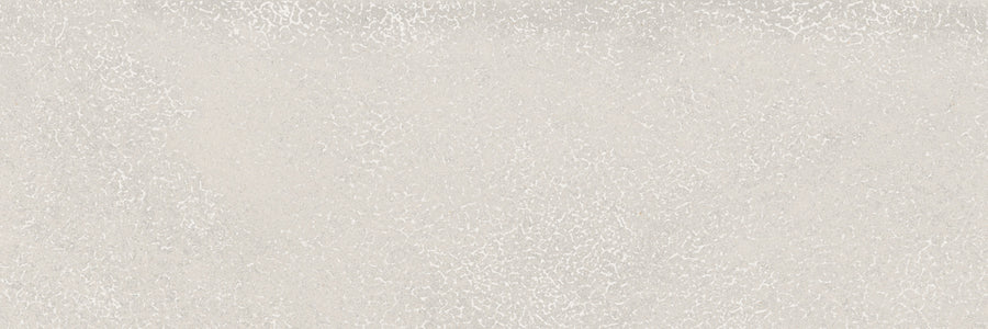Light grey textured surface with a subtle, mottled pattern and tiny white specks, resembling concrete or stone—features that define the calming aesthetic of Avanti 4x12 Glazed Porcelain Tile.
