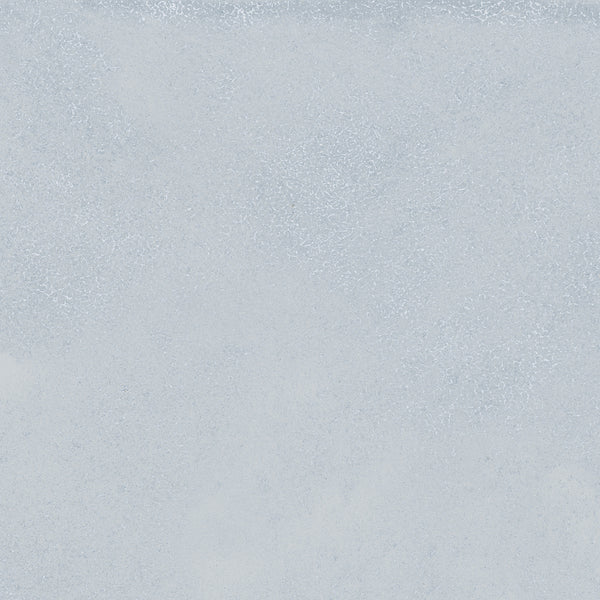 The Avanti 12x12 Glazed Porcelain Tile features a textured, light gray surface with subtle variations and speckles. Its uniform, neutral design offers a calming aesthetic, perfect for spaces seeking a tranquil atmosphere.