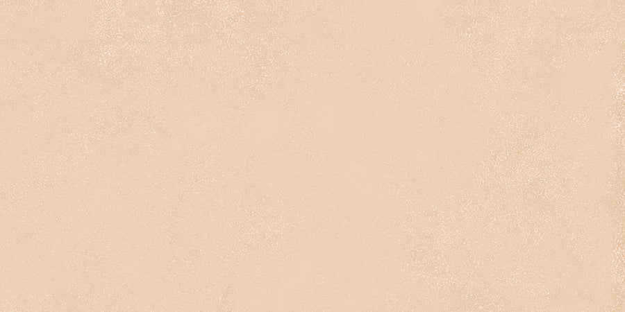 The Avanti 12x24 Rectified Glazed Porcelain Tile features a light beige, subtly speckled textured surface with a slightly grainy look, creating a calm and elegant aesthetic reminiscent of refined porcelain tiles.