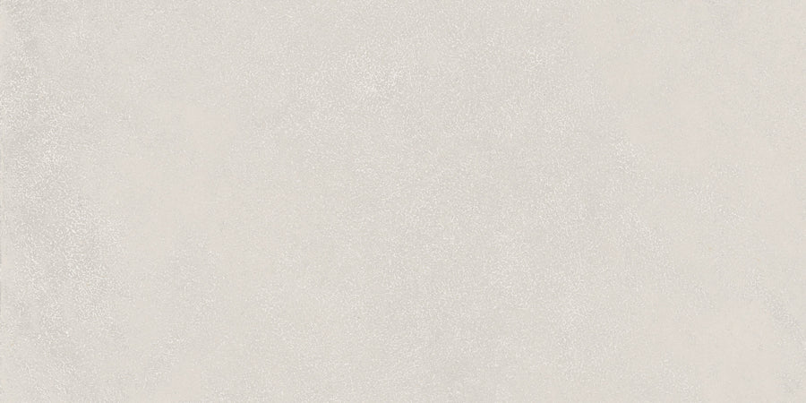 The Avanti 12x24 Rectified Glazed Porcelain Tile features a seamless light gray concrete look with a subtle speckled surface, providing a smooth, neutral aesthetic ideal for elegant, calming interiors.