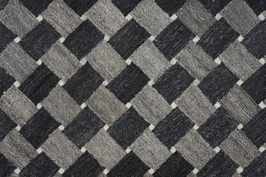 Atrium On Trend Carpet in Charcoal features a textured surface with a repeating checkerboard pattern of dark gray, light gray, and black diamonds, adding an elegant geometric and three-dimensional look to your flooring.
