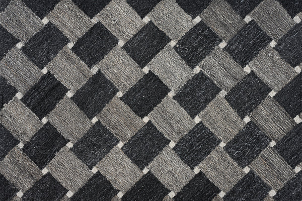 Atrium On Trend Carpet in Charcoal features a textured surface with a repeating checkerboard pattern of dark gray, light gray, and black diamonds, adding an elegant geometric and three-dimensional look to your flooring.