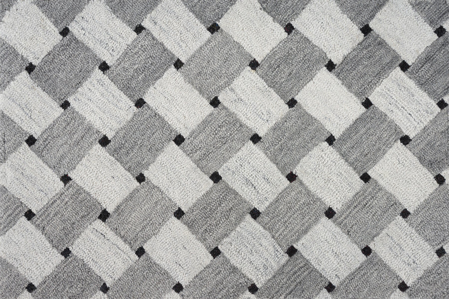 A close-up of the Atrium On Trend Carpet in gray reveals a textured surface with a repeating diamond pattern and small black dots—an elegant, modern flooring choice for contemporary interiors.