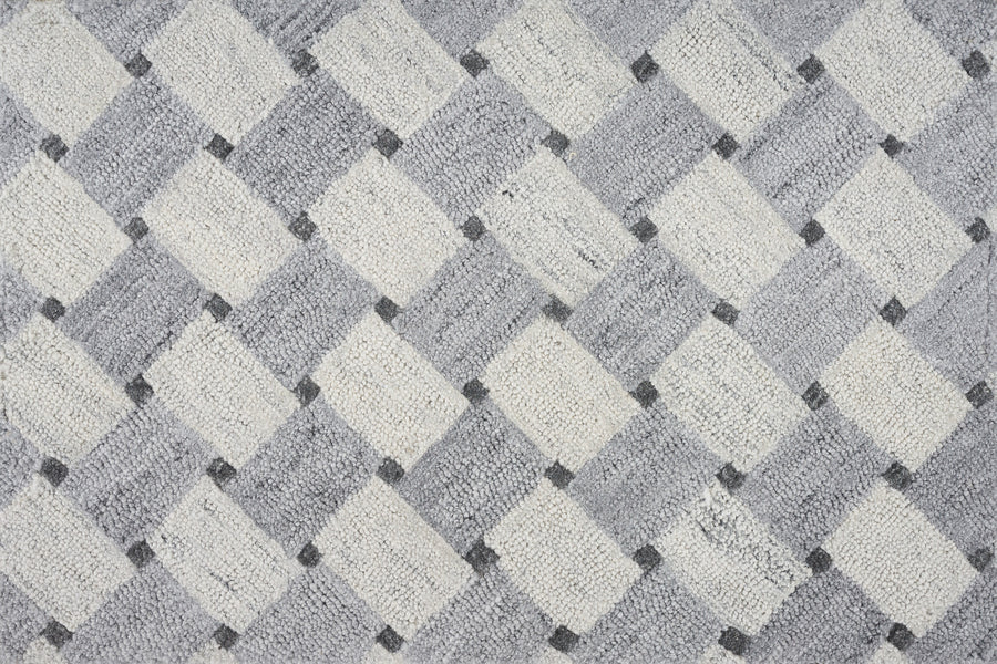 A close-up of the Atrium On Trend Carpet in Ice shows a textured surface with alternating light and dark diamonds in gray, white, and black, forming a modern geometric pattern ideal for contemporary interiors.