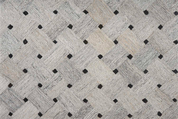 The Atrium On Trend Carpet in Stone features a woven basket-like texture with evenly spaced black square dots, providing durable and stylish flooring for any contemporary setting.