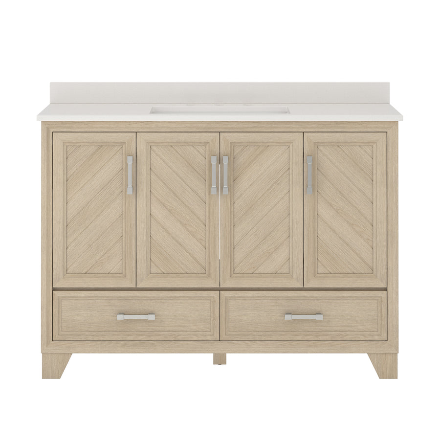 A light wood bathroom vanity with a white countertop, four chevron-patterned cabinet doors, and two drawers at the bottom, each with modern silver handles.