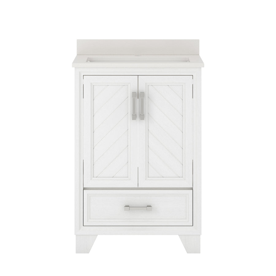 White bathroom vanity with chevron-patterned double doors, a single lower drawer with a handle, and a light-colored countertop. The design is modern and clean, featuring silver hardware.