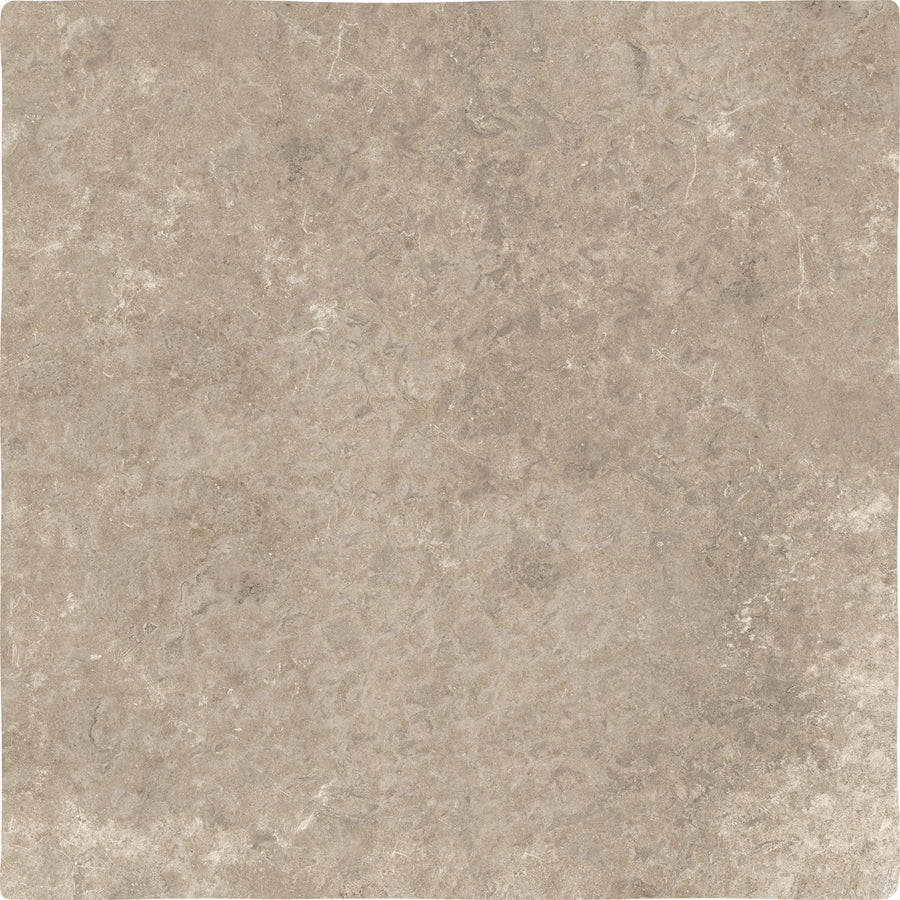 A close-up of the Abbey Stone XXL Ceramic Tile in Cluny color, showing its square shape and textured surface with natural beige tones and subtle variations in color and veining.