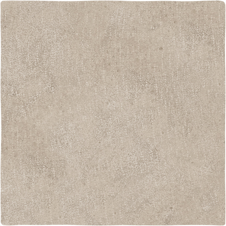 The Abbey Stone XXL Ceramic Tile in Rila features a square shape, beige color, textured speckled surface, and slightly uneven edges.