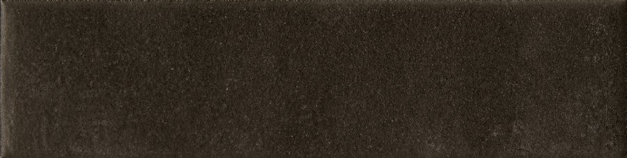 The Abode 2.5x9.5 Porcelain Tile is a rectangular, dark brown tile with a soft matte finish, subtle linear patterns, and slightly varied color that brings unique accent features to any space.