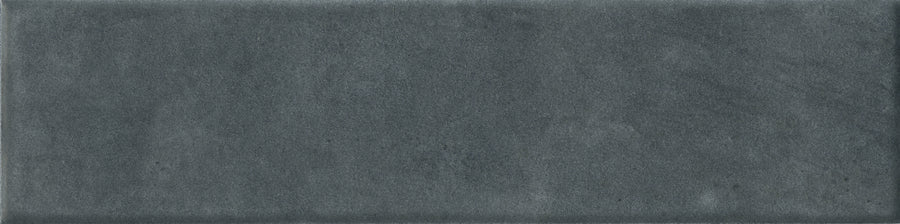 The Abode 2.5x9.5 Porcelain Tile features a rectangular, dark gray matte finish with a softly textured surface and gentle shade variations—ideal for accenting any space.