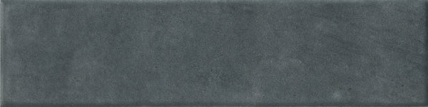 The Abode 2.5x9.5 Porcelain Tile features a rectangular, dark gray matte finish with a softly textured surface and gentle shade variations—ideal for accenting any space.