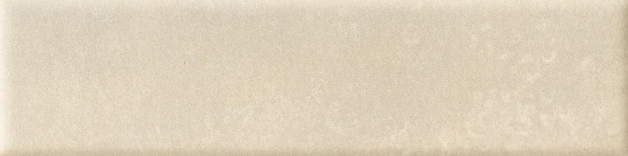 The Abode 2.5x9.5 Porcelain Tile features a rectangular, beige velvety finish with a smooth, slightly glossy surface and subtle cloudy patterns for a soft, natural look.